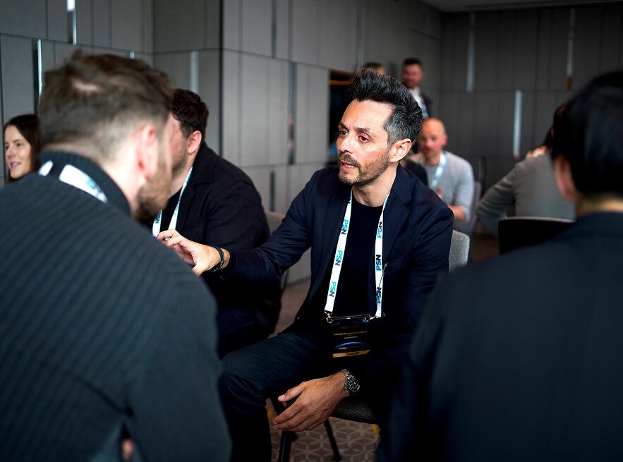 Man engaged in conversation during a professional networking event.